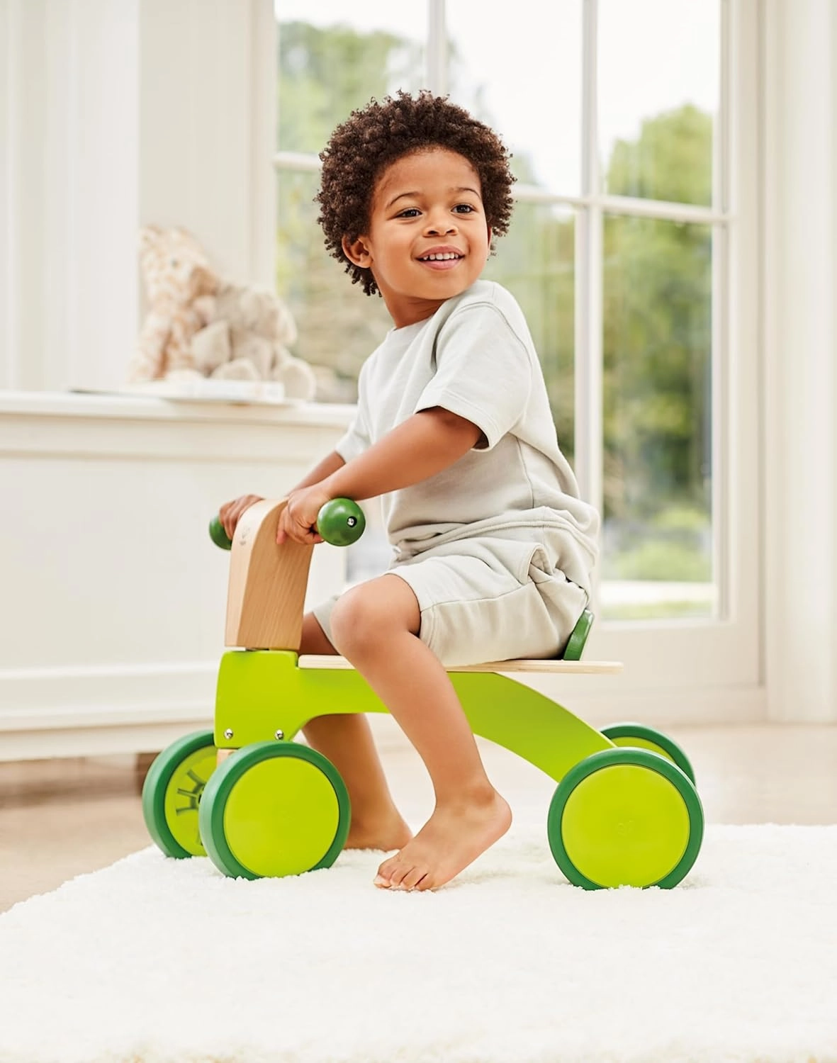 Hape Scoot Around Ride On Wood Bike | Award Winning Four Wheeled Wooden Push Balance Bike Toy for Toddlers with Rubberized Wheels, Bright Green